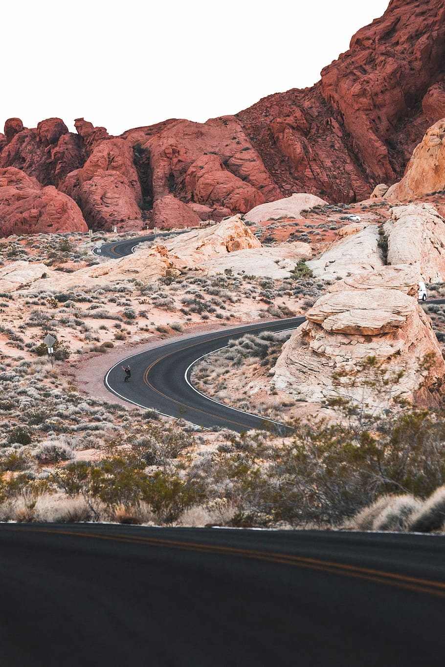 mountain near road at daytime, person going down the road, rock HD wallpaper
