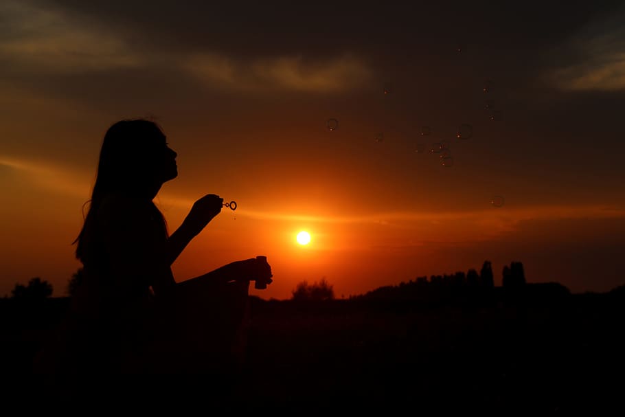 silhouette photo of a woman holding bubble making stick, sunset HD wallpaper