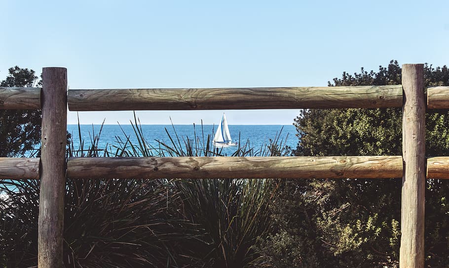 sea, water, ocean, boat, daylight, fence, grass, outdoors, scenic HD wallpaper