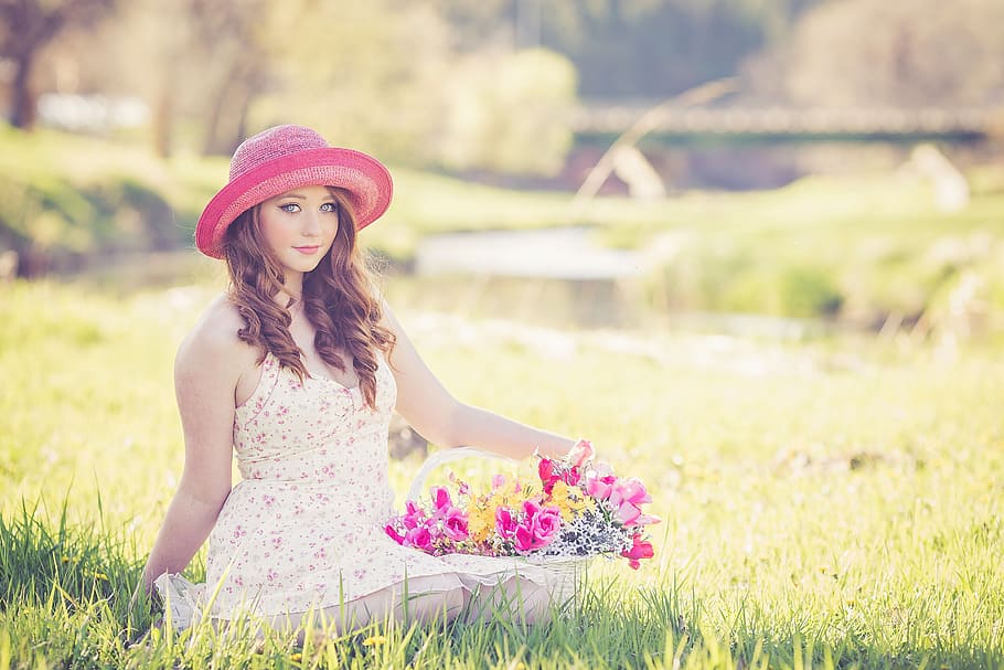 photo of a woman sitting on ground holding bouquet of basket flower HD wallpaper
