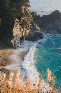 seashore during daytime, rock formation near seashore and body of water at daytime HD wallpaper