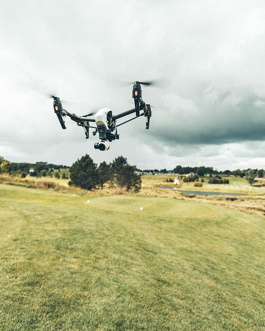 turned on white and black quadcopter drone, white and black quadcopter drone in mid air under white clouds HD wallpaper