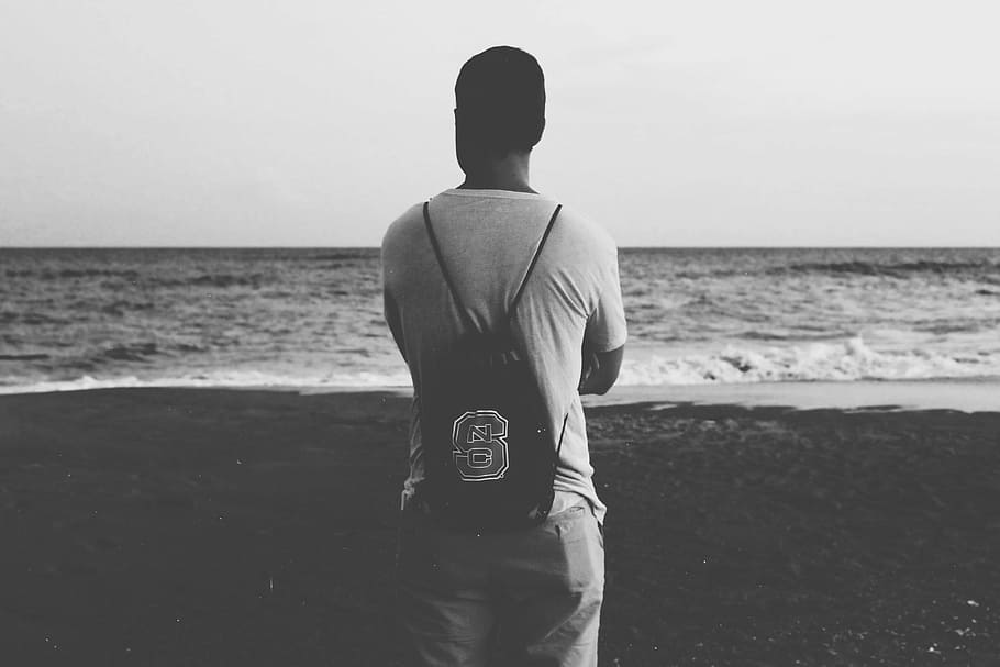 grayscale photography of man standing on seashore, guy, male