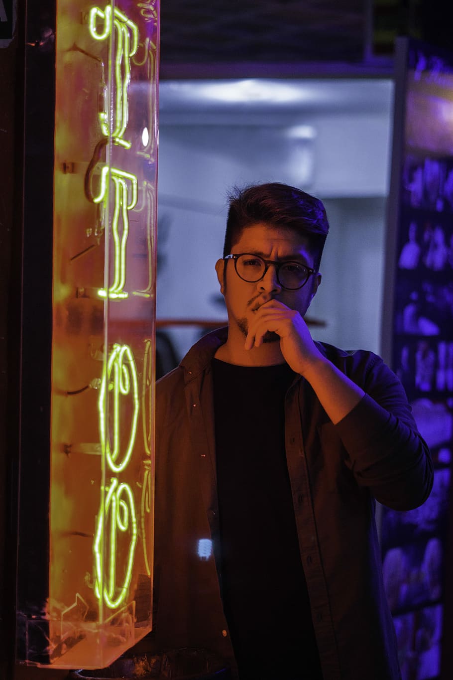 person standing beside turned on yellow neon pub signage, man standing beside tattoo neon sign, HD wallpaper