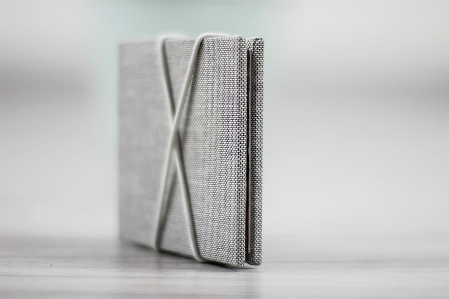 selective focus photo of board on wood plank, gray journal in selective focus photography HD wallpaper