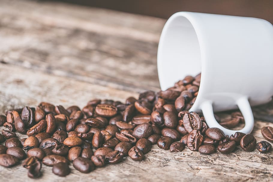 white ceramic mug and brown coffee beans on brown wooden board HD wallpaper