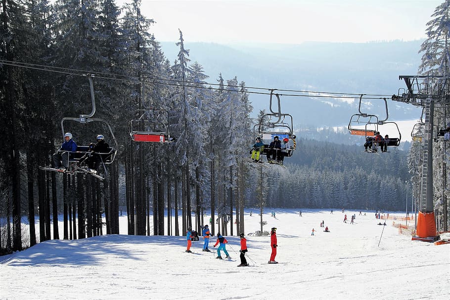 people riding cable cars during daytime, skiing area, chair lift