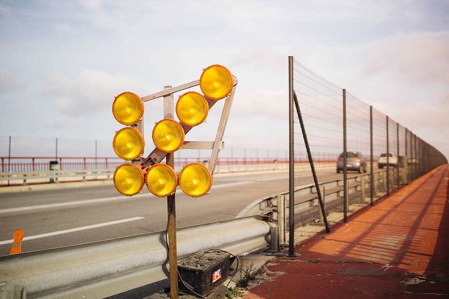 turned of yellow road lights, gray concrete road with vehicle passing by HD wallpaper
