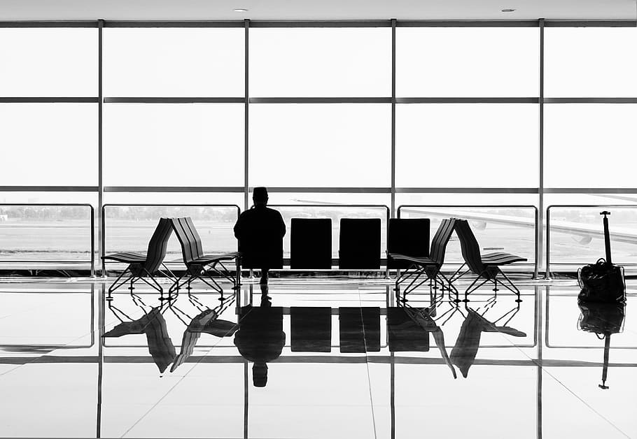 man sitting on gang chair during daytime, silhouette of a man sitting in front of airport windowpane HD wallpaper