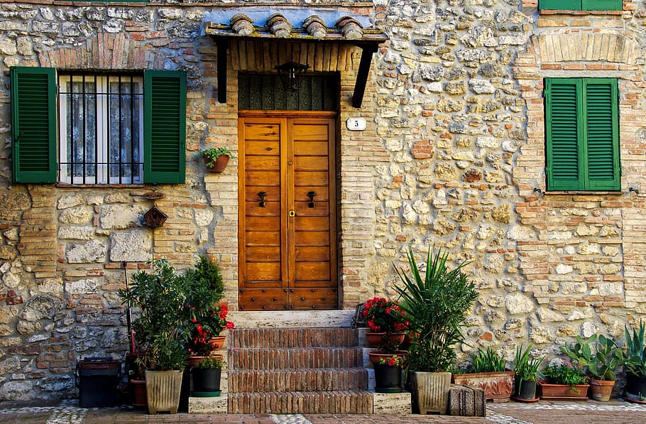 brown concrete house with brown wooden door, casa antica, middle ages