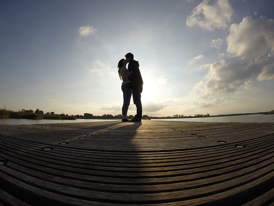 silhouette of kissing man and woman fish-eye photography, pair