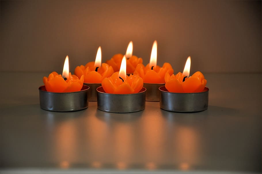 lighted orange tealight candles, burning, flame, celebration