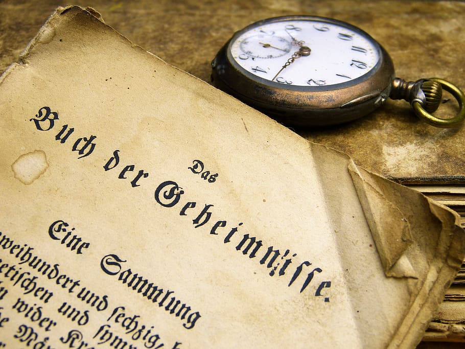 closeup photo of pocket watch, book, old, font, read, used, antique