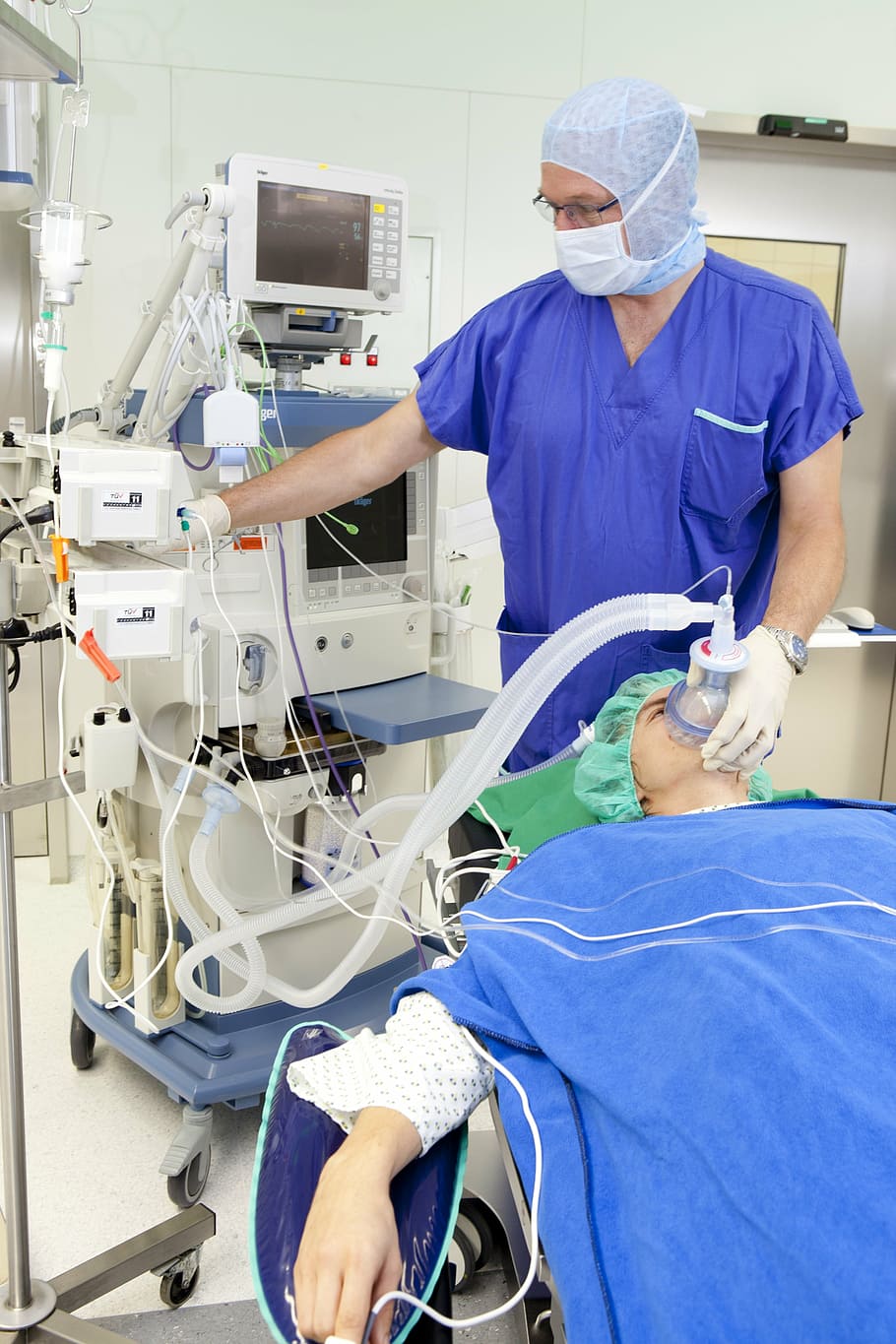 person using medical equipment on patient, operation, respiratory mask