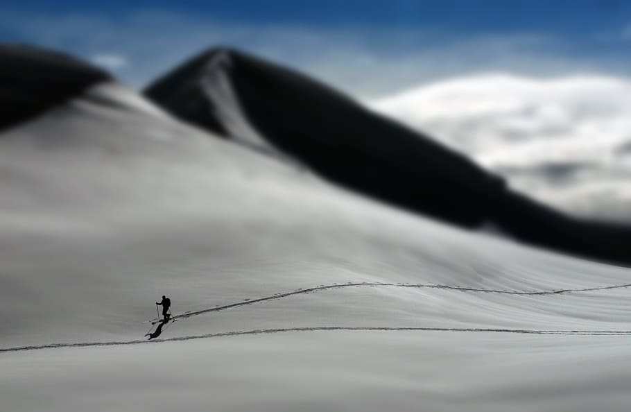 snow covered mountain, person walking on desert during daytime HD wallpaper