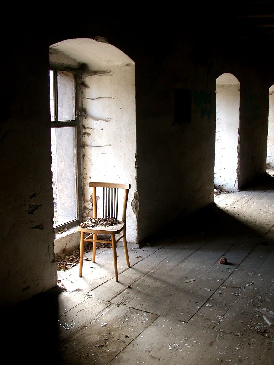 empty brown wooden chair beside glass window inside the building HD wallpaper