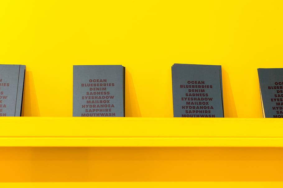 Blue & Yellow, four assorted books leaning on yellow painted wall HD wallpaper