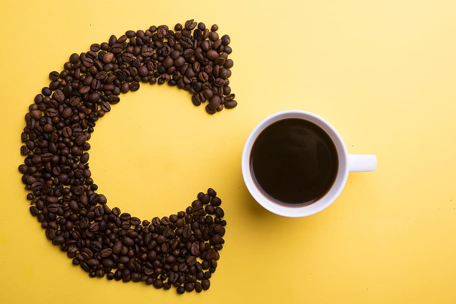 Coffee beans and cup on yellow background, food/Drink, caffeine