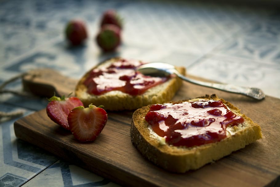 shallow focus photography of loaf bread with strawberry jam on brown wooden chopping board HD wallpaper
