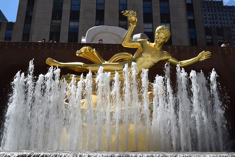 gold statue in fountain, prometheus fountain, rockefeller center