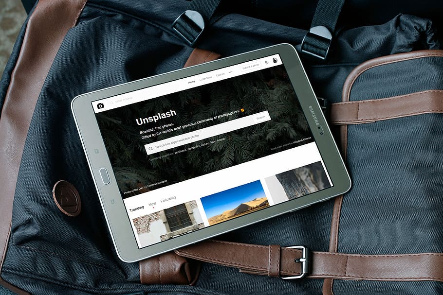 gray Samsung tablet turned on, turned on gray Samsung tablet computer on black bag HD wallpaper