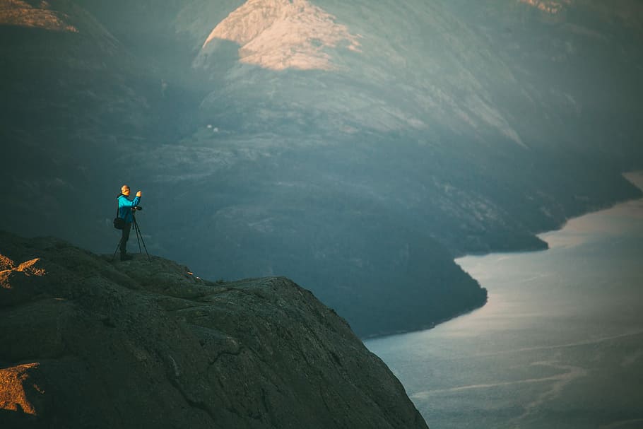 man standing on hill near lake, woman standing on top of mountain HD wallpaper