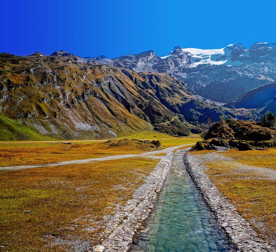 trees covered mountains, green grass field, mountains and river photo during daytime HD wallpaper