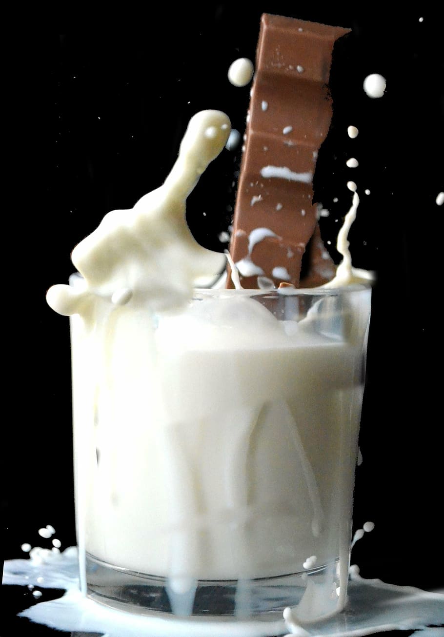 clear drinking glass filled with white liquid, milk chocolate