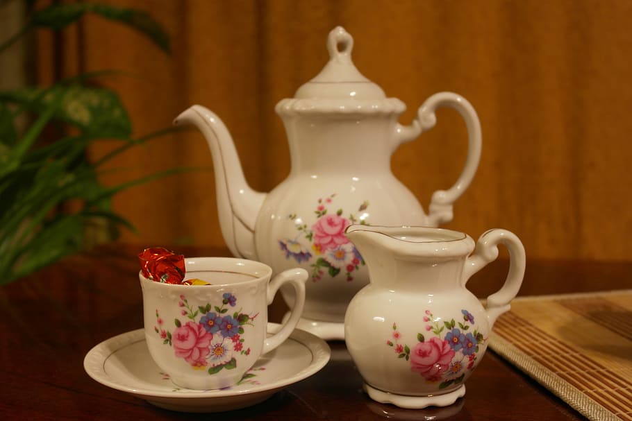 three white-and-pink floral ceramic tea set on brown wooden surface HD wallpaper
