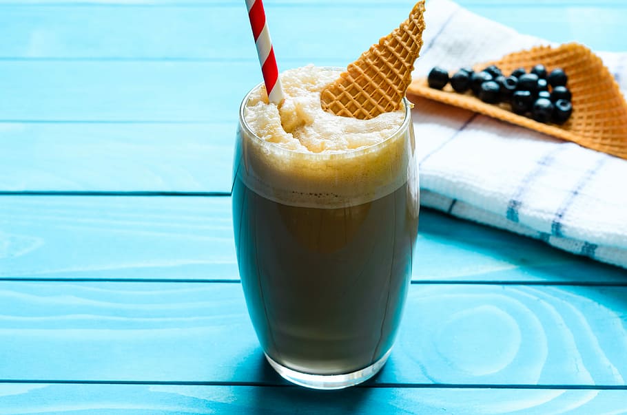 clear glass drinking cup filled with shake with waffle and straw beside towel on table HD wallpaper