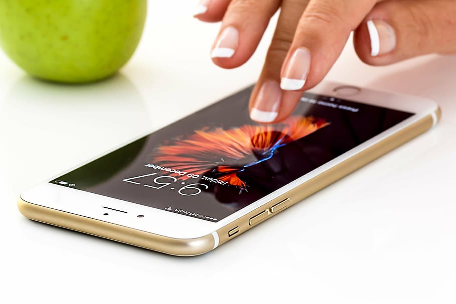 person touching gold iPhone 6, smartphone, cellphone, apple i phone