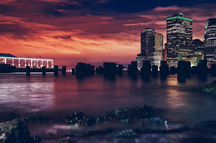 silhouette of buildings during sunset, panorama photography of high-rise building HD wallpaper