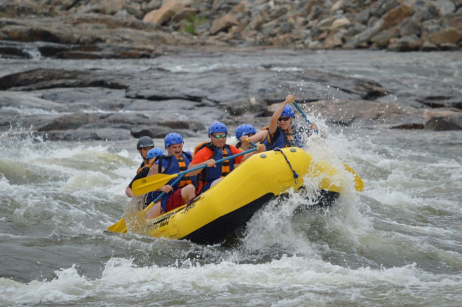 five person riding on yellow inflatable water raft, rafting, whitewater