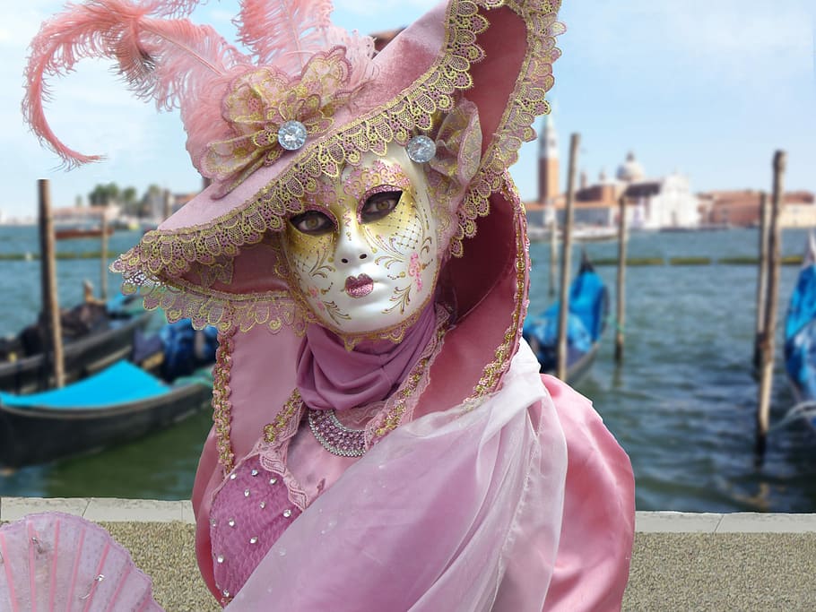 woman in pink Elizabeth collar dress near body of water, mask of venice