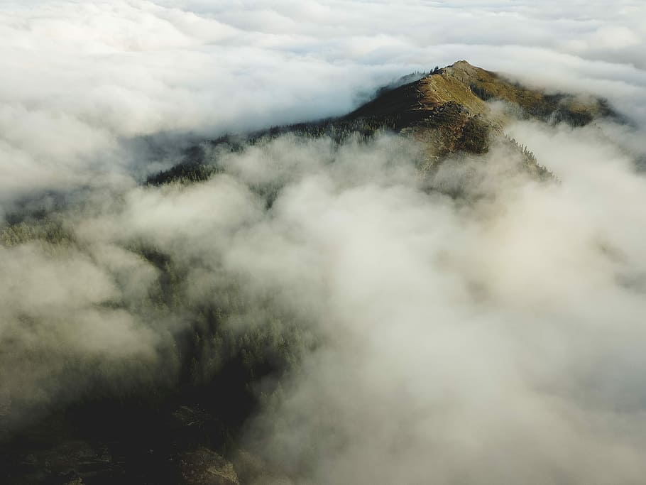 bird's eye view of mountain covered in sea of cloud, landscape photography of mountain HD wallpaper
