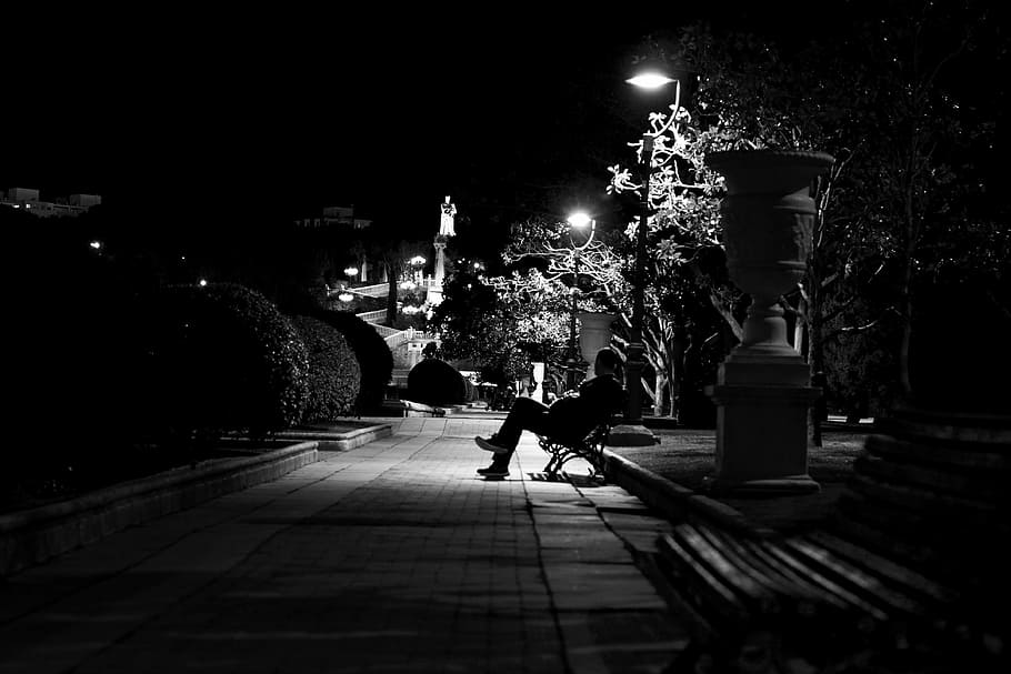 grayscale photo of person sitting on bench near street light HD wallpaper