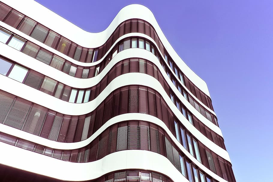 low angle view of white and brown glass building with purple sky HD wallpaper