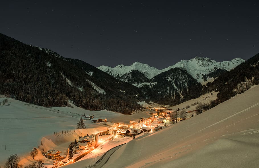 mountain cover snow, snow covered village overlooking mountains during nighttime HD wallpaper