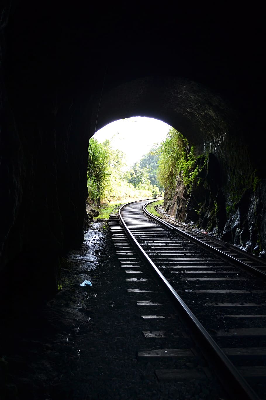 train rail under tunnel, railroad, light, light comes through