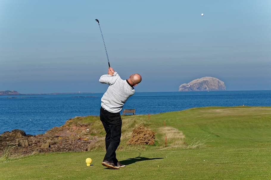 man playing golf on field, golf swing, golfer, swinging, male