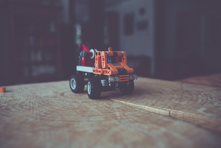 close up photography of lego truck toy on top of brown slab, selective focus photography of crane truck toy HD wallpaper
