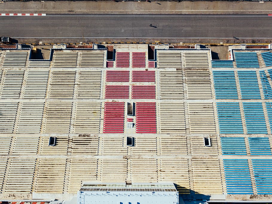 aerial photography of white, red, and blue chairs near black concrete race track, aerial view of road HD wallpaper