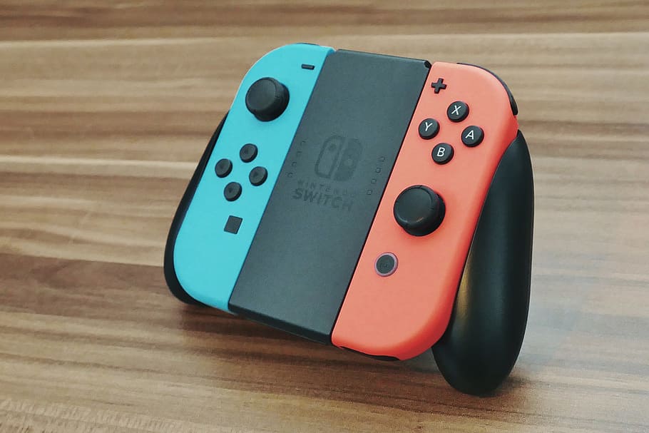 blue and orange Nintendo Switch on table, console, game, video