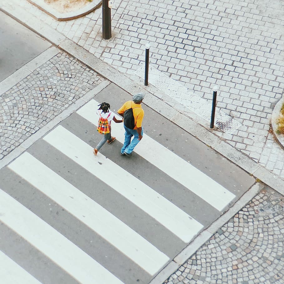 man and girl crossing on pedestrian lane, man and girl crossing pedestrian