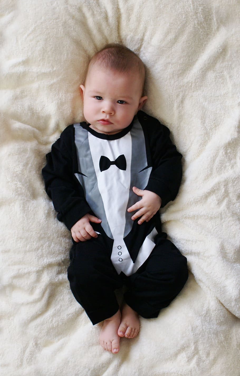 person showing baby's tuxedo-themed footie, babe, newborn, gentleman