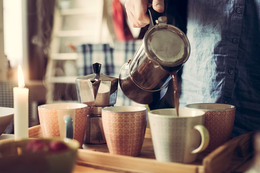 person pouring tea on white ceramic mug using teapot beside moka pot, person pouring coffee on white coffee cup, HD wallpaper