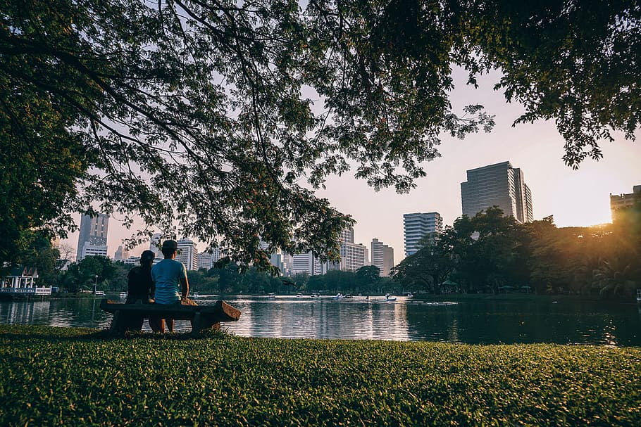 two person sitting near body of water at daytime, accommodation HD wallpaper
