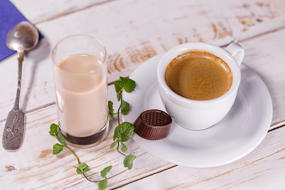 white ceramic teacup and white ceramic saucer beside clear drinking glass and gray stainless steel spoon HD wallpaper