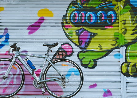 gray city bike park on near roller shutter, gray and black bicycle stand by near to door shutter HD wallpaper