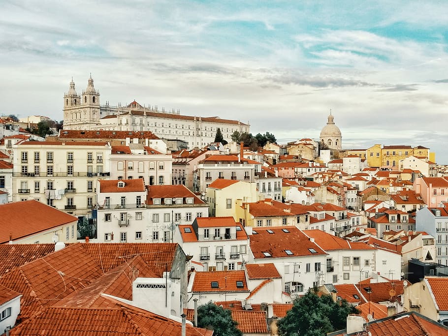 city landscape photography during daytime, city houses under white cloud HD wallpaper